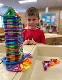 A child playing with a colorful plastic blocks
AI-generated content may be incorrect.