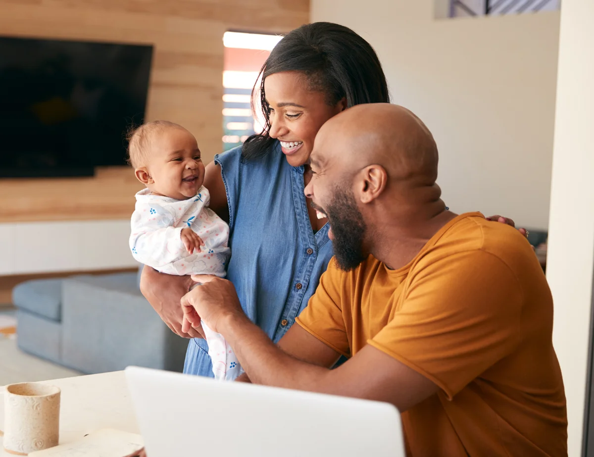 parents holding baby